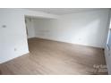 Bright living room featuring wood-look floors and lots of natural light at 8915 Touchstone Ln, Charlotte, NC 28227