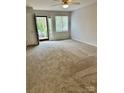 Bright living room with neutral carpet, a ceiling fan, and access to the outside at 1049 7Th Ne St, Hickory, NC 28601