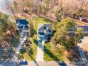 Aerial view of a well-maintained home, showcasing its landscaped yard and neighborhood setting near the lake at 110 Hazelton Loop, Mooresville, NC 28117