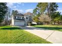Well-maintained home with a two-car garage, lush lawn, and manicured landscaping, creating curb appeal at 110 Hazelton Loop, Mooresville, NC 28117