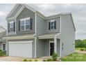 Charming two-story home with gray siding, black door, white trim, well maintained lawn and flower bed at 1101 Red River Dr, Salisbury, NC 28144