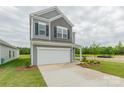 Charming two-story home with gray siding, attached two-car garage and a long concrete driveway at 1101 Red River Dr, Salisbury, NC 28144