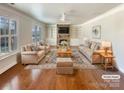 Bright living room with hardwood floors, built-in shelves, a fireplace, and neutral furniture at 11123 River Oaks Nw Dr, Concord, NC 28027