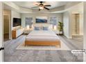 Main bedroom with a tray ceiling, a ceiling fan, and a walk-in closet at 11123 River Oaks Nw Dr, Concord, NC 28027