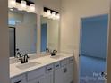Elegant bathroom featuring a double sink vanity with white quartz countertops and modern black fixtures at 1120 Red River Rd, Salisbury, NC 28144