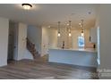 Open-concept living area showcasing wood floors, a kitchen view, and ample natural light at 1120 Red River Rd, Salisbury, NC 28144