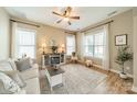 Cozy living room with abundant natural light, ceiling fan, and a charming fireplace feature at 1122 Saratoga Blvd, Indian Trail, NC 28079