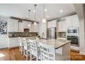 Bright kitchen featuring a large center island, stainless steel appliances, and elegant pendant lighting at 12811 Elkhorn Dr, Charlotte, NC 28278