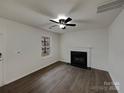 Cozy living room featuring a fireplace, window, and neutral color palette at 1411 Swaying Branch Ln, Clover, SC 29710