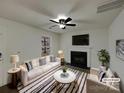 Bright living room featuring modern furniture, fireplace, and neutral color palette at 1411 Swaying Branch Ln, Clover, SC 29710