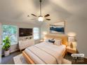Bright bedroom featuring a large window, ceiling fan, and modern decor at 1411 Swaying Branch Ln, Clover, SC 29710