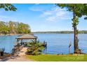 Beautiful dock with gazebo offers serene waterfront views on a sunny day at 16 Sunrise Point Ct, Lake Wylie, SC 29710