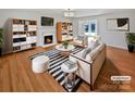 Bright living room featuring a fireplace, hardwood floors, and stylish contemporary furnishings at 189 Beech Brook Ln, Statesville, NC 28625