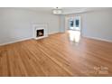 Spacious living room boasts gleaming hardwood floors and a cozy fireplace at 189 Beech Brook Ln, Statesville, NC 28625