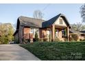A quaint brick home with a well-manicured lawn and a welcoming front porch at 1937 Wilmore Dr, Charlotte, NC 28203