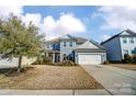 Charming two-story home with blue siding, white trim, and a well-manicured front yard at 2056 Angel Oak Dr, Fort Mill, SC 29715