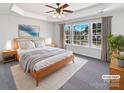 The main bedroom features tray ceilings, large windows, and is flooded with natural light at 21005 Brinkley St, Cornelius, NC 28031