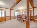 Spacious dining room featuring wood beam accents, a classic chandelier and a large table at 2615 High Ridge Church Rd, Marshville, NC 28103