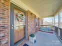 Inviting front porch with a porch swing and decorative wreath, perfect for relaxing outdoors at 2615 High Ridge Church Rd, Marshville, NC 28103