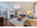 Cozy living room with fireplace, hardwood floors and view into dining area at 304 W Park Ave, Charlotte, NC 28203