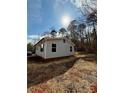 Well-maintained single-story home with gray siding complemented by the natural beauty of its surroundings at 3437 Wilkesboro Hwy, Statesville, NC 28625