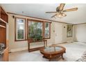 Bright living room featuring a ceiling fan, large windows, and natural light at 3660 Fieldcrest Nw Cir, Concord, NC 28027