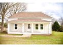 Inviting single-story home with classic white brick and a covered front porch at 405 Aquadale Rd, Albemarle, NC 28001
