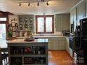 Well-lit kitchen featuring custom cabinets, modern appliances, and an island at 511 Glencurry Dr, Charlotte, NC 28214