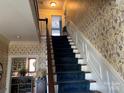 Carpeted staircase with decorative wallpaper leading to the upper level at 511 Glencurry Dr, Charlotte, NC 28214