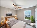 Serene bedroom with a queen bed, soft gray walls, a modern ceiling fan, and a picturesque window view at 732 Victory Gallop Ave, Clover, SC 29710