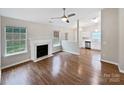 Bright, open living room with hardwood floors, a fireplace, large windows and easy access to the kitchen at 732 Victory Gallop Ave, Clover, SC 29710