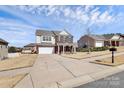 Suburban two-story home with a wide driveway, brick accents, well-maintained lawn, and inviting curb appeal at 815 Oak Embers Se Dr, Concord, NC 28025