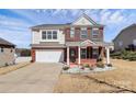 Two-story home boasts a brick facade, an attached garage, and a meticulously kept front yard with mature shrubs at 815 Oak Embers Se Dr, Concord, NC 28025