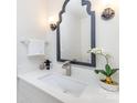 Stylish bathroom with modern vanity, updated faucet, and decorative mirror at 8322 Knights Bridge Rd, Charlotte, NC 28210