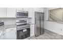 Modern kitchen showcasing stainless steel appliances, granite countertops, and bright white cabinetry at 8322 Knights Bridge Rd, Charlotte, NC 28210