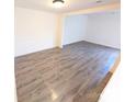 Spacious living room with modern wood-look flooring and neutral paint at 8322 Knights Bridge Rd, Charlotte, NC 28210