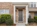 Inviting front entrance features a stylish gray door, brick facade, and manicured bushes at 840 Imperial Ct, Charlotte, NC 28273