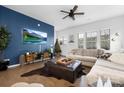 Bright living room with a blue accent wall, hardwood floors, and an entertainment center at 840 Imperial Ct, Charlotte, NC 28273