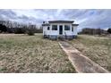 Front view of the house with a small porch and concrete path leading to the entrance at 930 Weaver Rd, China Grove, NC 28023