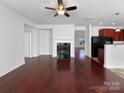 Bright living room with hardwood floors, fireplace, and access to the kitchen at 9407 Seamill Rd, Charlotte, NC 28278