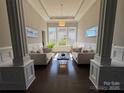 Bright living room featuring elegant columns, with neutral furniture and large windows for ample natural light at 1005 Cherry Laurel Dr, Waxhaw, NC 28173