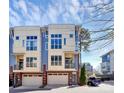 Modern townhome featuring a 1-car garage, brick facade, and blue and cream exterior paint at 1037 Pierre Dr, Charlotte, NC 28205