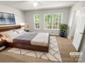 Cozy bedroom with large windows, plush carpet, and stylish wood furniture at 1269 E Woodlawn Rd, Charlotte, NC 28209