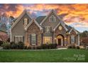 Charming home featuring stone accents, a well-manicured lawn, and a welcoming front entrance at 13500 Robert Walker Dr, Davidson, NC 28036