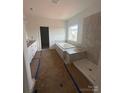 Bathroom features a soaking tub, separate shower, and a double vanity, awaiting final touches and customization at 136 Glenn Dr, Mooresville, NC 28115