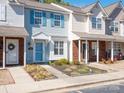 Charming townhome featuring light blue siding and well-maintained landscaping at 13684 Meade Glen Ct, Charlotte, NC 28273