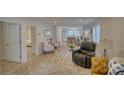 Open-concept living room with hardwood floors and a view to the kitchen beyond at 1532 South Point Rd, Belmont, NC 28012
