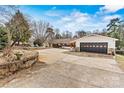 View of the home featuring an attached garage and spacious driveway at 156 Hazelton Loop, Mooresville, NC 28117