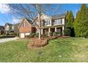 Attractive home with brick and siding, a well-kept lawn, and mature trees at 2000 Willowcrest Dr, Waxhaw, NC 28173