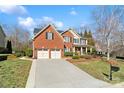 Beautiful two-story brick home featuring a well-maintained lawn and a spacious driveway at 2000 Willowcrest Dr, Waxhaw, NC 28173